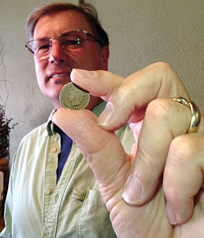 Mike Kilpatrick, co-owner of Verde Valley Olive Oil Traders in Old Town Cottonwood, shows-off his 1881 Indian head penny. (Photo courtesy of Dawn Waltman).