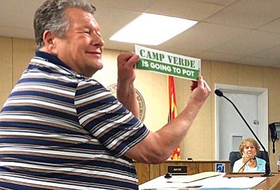 Murray Lichty gives staff and council his concerns, and a bumper sticker proclaiming the town “is going to pot,” during Call to Public Wednesday night. (Photo by Tom Tracey)