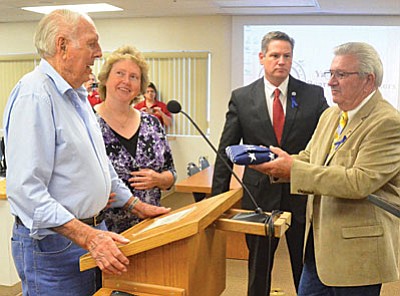 Cottonwood’s James L. Oliver receives the Yavapai County Superior Courthouse flag in honor of his 100th birthday. From left are grandaughter Kathy Silvas and Yavapai County Supervisors Jack Smith and Craig Brown (presenting flag). (Photo by Vyto Starinskas).