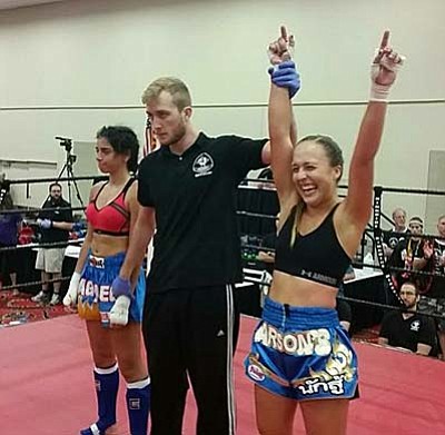Shayna Murdock has her hands raised after winning championship belt. Courtesy Photo