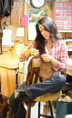 <br>Ryan Williams/WGCN<br>
Tamara Bloomberg repairs a saddlebag.