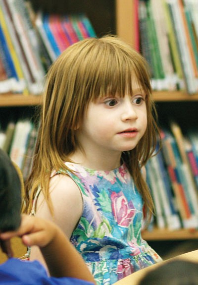 Ryan Williams/WGCN<br>

Three-year-old Clara Martinez listens along to the story at the Williams Public Library.