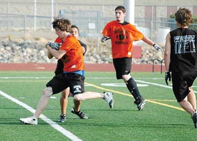 Cheryl Hartz/Prescott Valley Tribune<br>
Doug Forbis eludes a defender during a Bradshaw Mountain Passing League game July 8. The Vikings football squad begins two a day practices Aug. 2.