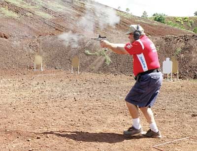 Submitted photo<br>
A competitor fires away at the Aug. 29 practical pistol shooting match held at the Williams Shooting Range located near the junction of Highway 64 and Interstate 40.