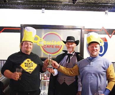 Submitted photo<br>
Chuck Vaughn (center), organizer of the Wicked Wing Throw Down, presents a trophy to Steve Dryer  Oct. 30 at Cruiser’s. The Dryer Brothers were selected  winners of the delicious contest.