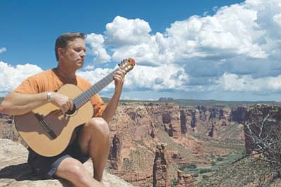 James Hunley plays his classical guitar at the edge of Grand Canyon. Submitted photo