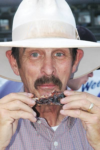 Williams Mayor John Moore samples ribs at a past Northern Arizona BBQ Festival.