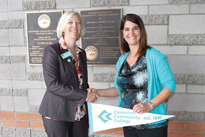Coconino Community College President Leah Bornstein hands over the keys to the college building to Williams Unified School District Superintendent Rachel Savage July 1.  Submitted photo