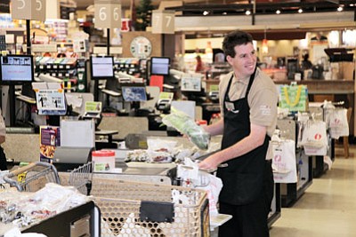 Mark Konkel, a Camp Civitan Day Treatment and Training program client, works at the Williams Safeway. Ryan Williams/WGCN