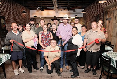 Members of the Williams-Grand Canyon Chamber of Commerce and Saddlebag Sandwich Shop employees celebrate the grand opening of the new eating establishment, located on Route 66. Ryan Williams/WGCN