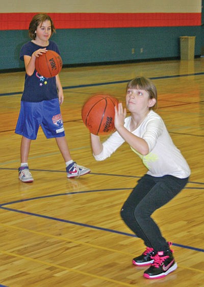 Shaelee Echeverria, 9, of Williams, takes a warm-up shot Jan. 18 during the Chino Valley Elks Hoop Shoot at Heritage Middle School gym in Chino Valley, where she took first in her age category for girls. Salina Sialega/Chino Valley Review