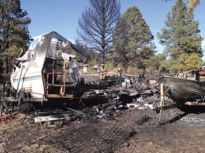Fire fighters mop up after a fire destroyed two trailers and a shed in the Pineaire subdivision south of Parks. Photo/Ponderosa Fire