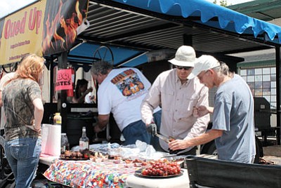 The Cued Up barbeque team toils over the grills during last year’s Northern Arizona Barbeque Festival. Photo/WGCN