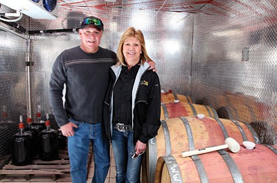Louie and Ann Serna stand next to wine casks at Wagon Wheel Winery. The two hope to sell wine at the location but the location of their winery is not zoned accordingly. Ryan Williams/WGCN