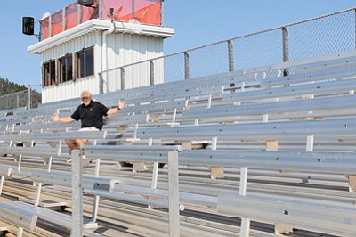 Athletic Director Phillip Echeverria sits in empty stands at Williams High School football field. Echeverria hopes the community will fill the stands this year to support student athletes. Wendy Howell/WGCN