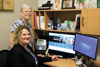 North Country HealthCare employees Sarah Kircher and Marilyn Fogg demonstrate how to navigate the Healthcare.gov website. Wendy Howell/WGCN
