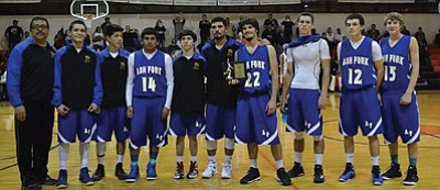 Ash Fork Spartans varsity basketball players display their trophy after placing second in the Route 66 Holiday Classic Basketball Tournament Dec. 3-5. Pictured from left: Coach Sonny Martin, Lucas Escabado, Cesar Acosta, Juan Ayala, Damian Quijada, Jose Cohen, Ashton Atkinson, Rian Gutierrez, Antonio Cisneros and Conner Makeeta. Photo courtesy of Sue Atkinson