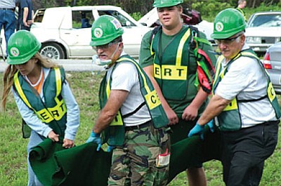 CERT volunteers help carry a victim during a training. Photo/courtesy of FEMA.gov