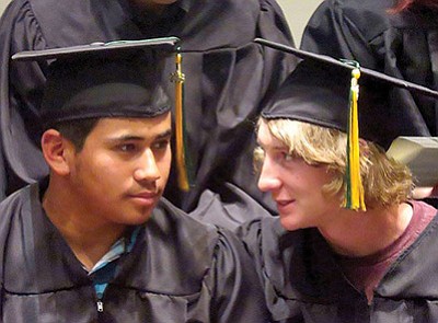 Juan Ayala, left, and Conner Maketa take part in Yavapai College graduation ceremonies on May 7 when they received their Electric Utility Technology certificates after completing the two-year program. Maketa graduates from Ash Fork High School this year and Ayala will be a senior next year. Submitted photo