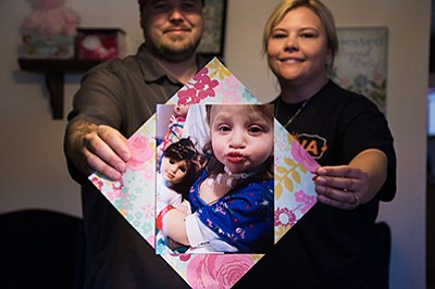 Williams residents Dan and Elizabeth Gordon hold a photo of their daughter, Lexi, who passed away in February of complications from cancer. The Gordon’s are raising money and collecting craft supplies to donate to the Pediatric Wing of Flagstaff Medical Center in memory of Lexi. Ryan Williams/WGCN