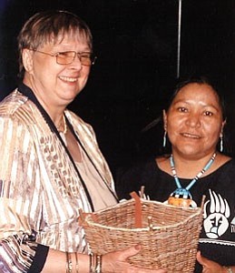 Williams Unified School District visual arts teacher Bonnie Dent, at left, accepts a gathering basket from the Hopi artist who made it ‹ Dorleen Gashweseoma Lalo ‹ at the  25th Anniversary Governor¹s Arts Awards Dinner on April 18. Dent received the piece from Gov. Napolitano for the Arts in Education award she was chosen for.