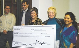 Governor Janet Napolitano presents a check to representatives of the Williams Alliance Against Drug Abuse on Oct. 16. The $76,000 grant will be used to address underage binge drinking in and around Williams. Pictured from left are: David McIntire, Brad Massey, Gov. Napolitano, Beth Britton and Patricia Helgeson.