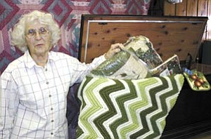 Madge Davis displays items inside a cedar chest that will be raffled off Nov. 10 at the Community United Methodist Church’s annual bazaar.