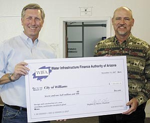 ADEQ Director Steve Owens presents a check for $7.5 million to Williams Mayor Ken Edes for the city’s new wastewater plant.