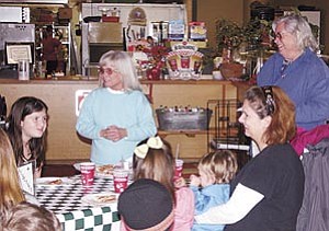Carol Glassburn, pictured center,  thanks the children in the SOAR after school prgram for their hard work ringing bells for the Salvation Army’s Red Kettle program. Children were treated to a free pizza party on behalf of Pizza Factory owners Chuck Coleman and Carla Ou.