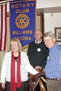 Williams resident JoDean Candler displays the family saddle she donated to the Western Auction during the Jan. 24 meeting of the Williams Rotary Club. The saddle, worth $500 to $600, was used to ride Whiskey Jack in the Cave Creek Fiesta Day Rodeo for a number of years. Also pictured are Rotarians Jim Bultema, far right, and Williams Mayor Ken Edes.