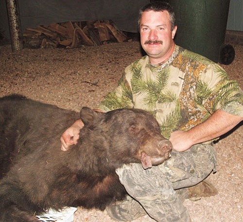 <br>Submitted photo<br>
Chris Binns with the large black bear he killed in Unit Eight near Williams.