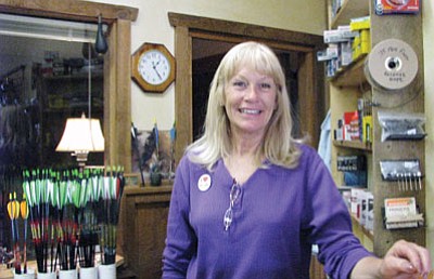 Kathy Fichera stands behind the counter at The Outdoor Store. The sporting goods store, located in the Pine Mountain Plaza behind Family Dollar, recently opened.