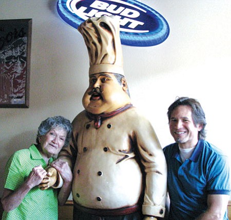 Lynda Duffy/WGCN
Carla Ou and Chuck Coleman share a light moment with Luigi, the most photographed fixture in the restaurant. While Ou and Coleman have sold Pizza Factory, Luigi will remain. "I'll miss him," Ou said.