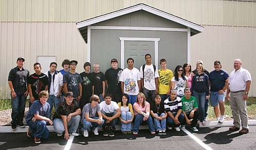 Patrick Whitehurst/WGCN
Williams High School Teacher Sheldon White (far right) and Shawn Cureton (second from right) with Old Trails stand with students in White's Skills USA/VICA class. The students are pictured with the first shed they built for the class, which is on display at Old Trails.
