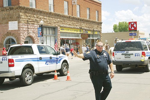 <br>Patrick Whitehurst/WGCN<br>
Williams Police Chief Herman Nixon directs traffic during a summer event in Williams. Organizers plan to honor police and fire officials for their part in the recent Twin Fire.