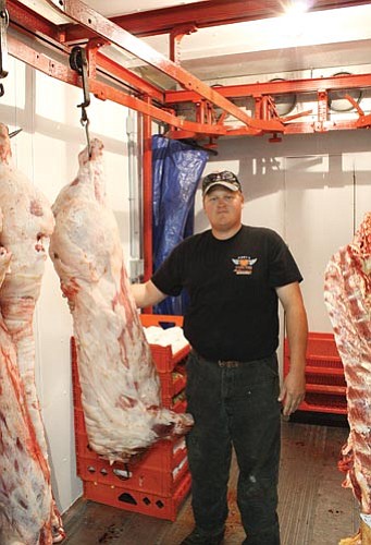 <br>Ryan Williams/WGCN<br>
Arizona Mobile Meat Processing proprietor Jake Giles displays recently processed pigs inside his custom built butcher shop on wheels. Giles serves all of northern Arizona.