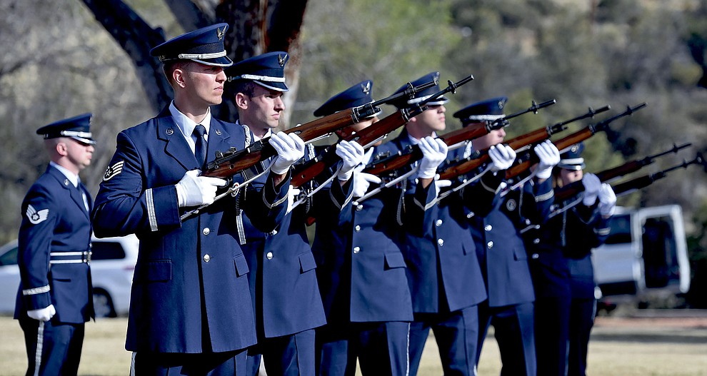 Members of the Davis–Monthan Air Force Base Honor Guard fire their rifles for the 21-gun salute Tuesday morning at the Prescott National Cemetery during the funeral for Air Force Brigadier General Duane Harold "Leif" Erickson in Prescott.