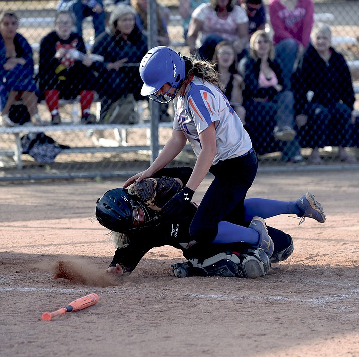 Chino Valley’s Audrey Tyler (19) collides with Mayer’s Lakin Dodge (12) at home plate Friday afternoon in Chino Valley.  Tyler was called out. 