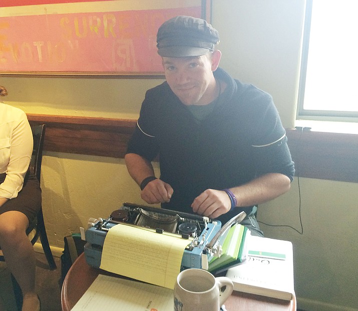 Sean Kauffman types on his Brother manual typewriter at the Wild Iris Coffee House on South Granite Street.