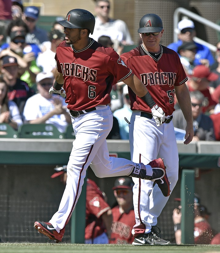 Arizona Diamondbacks' David Peralta is congratulated by third base coach Glenn Sherlock after hitting a two run home run in the first inning of a spring training baseball game against the Kansas City Royals, Saturday, March 12, 2016 in Scottsdale, Ariz.
