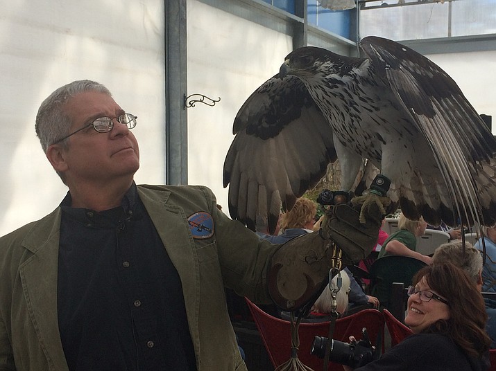 Paul Schnell with Hilda, the African Hawk Eagle, at Watters Garden Center Saturday. 