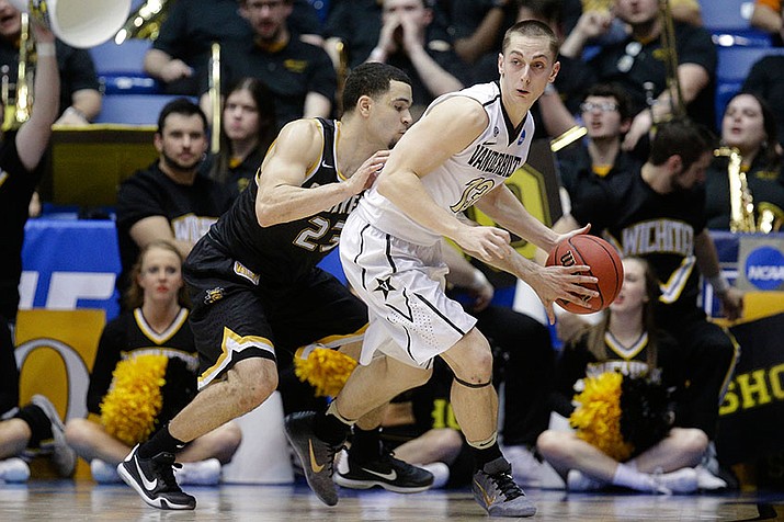 Wichita State's Fred VanVleet (23) steals the ball from Vanderbilt's Riley LaChance (13) during the second half of a First Four game of the NCAA men's college basketball tournament, Tuesday, March 15, in Dayton, Ohio. Wichita State won 70-50.