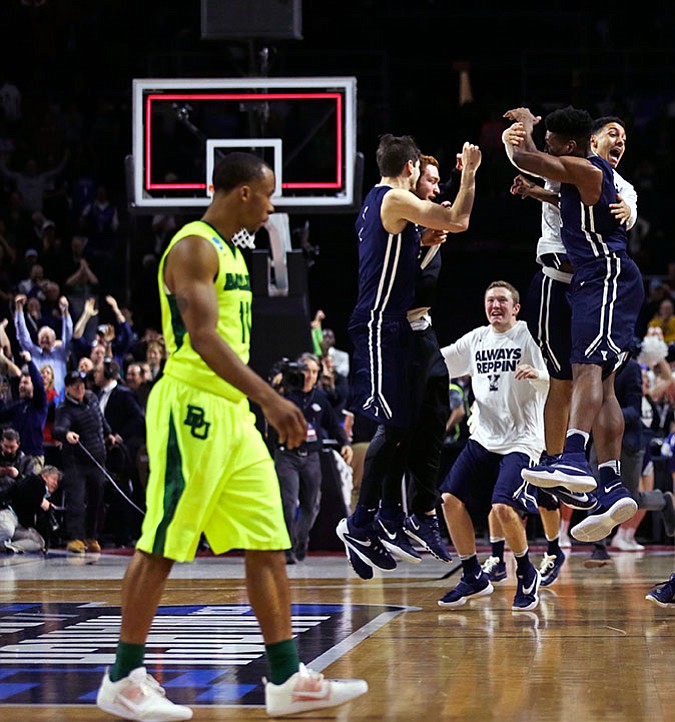 Yale celebrates their victory as Baylor guard Lester Medford (11) walks off the court Thursday. Yale defeated Baylor 79-75.