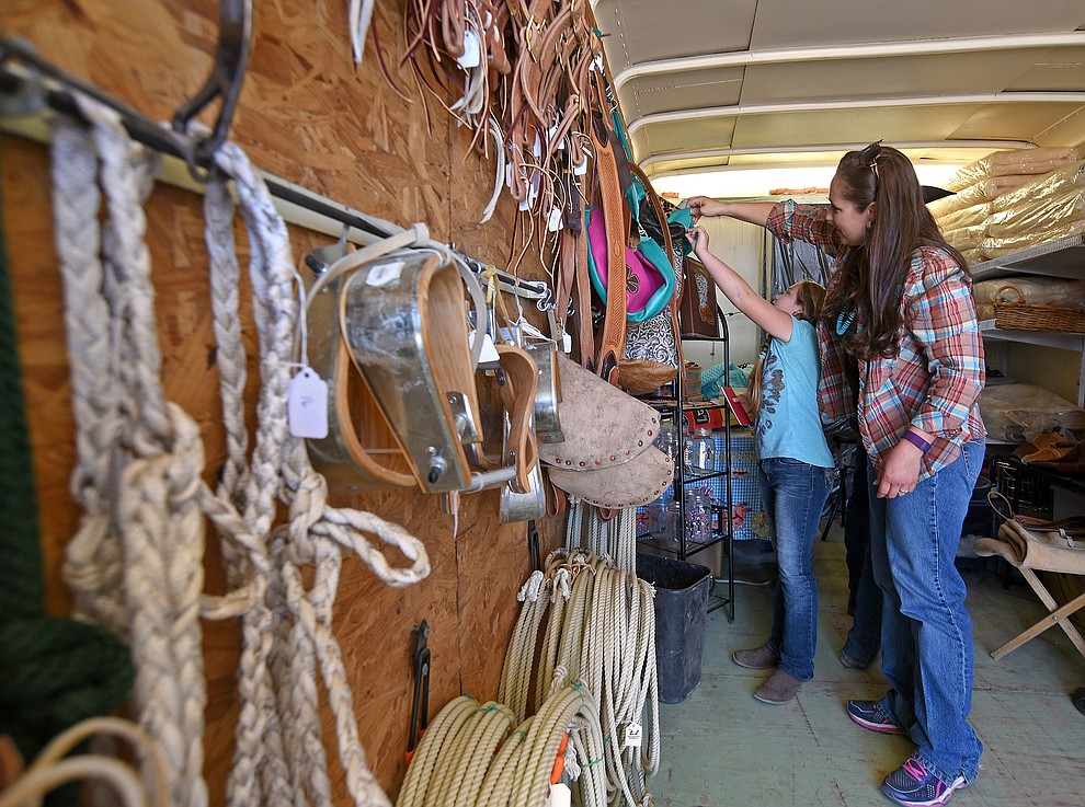 Lindsey Jeans and her daughter Tatum, 8, look for some new tack at the All Things Cowboy trailer during the Cattleman’s Trade Show Friday afternoon March 18, 2016 during the first day of the 25th Annual Cattleman's Weekend at the Prescott Livestock Auction in Chino Valley. (Matt Hinshaw/The Daily Courier)