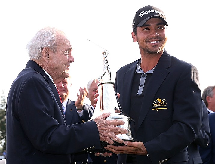 Arnold Palmer, left, presents the championship trophy to Jason Day of Australia after Day won the Arnold Palmer Invitational golf tournament in Orlando, Fla., Sunday, March 20.