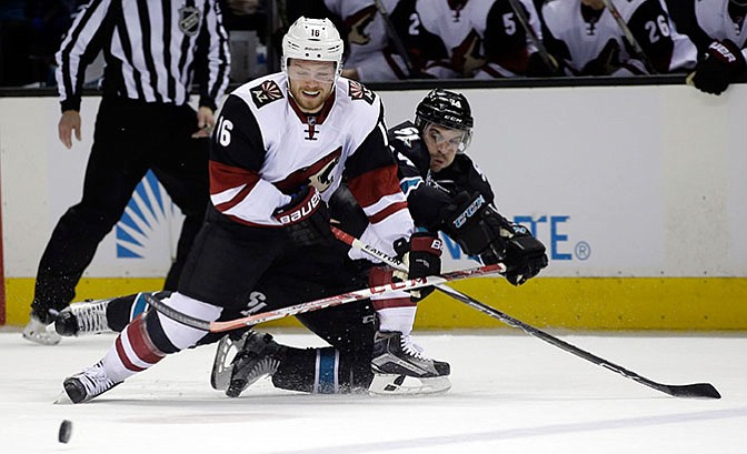 Arizona Coyotes' Max Domi (16) battles against San Jose Sharks defenseman Dylan DeMelo (74) during the second period of an NHL hockey game Sunday, March 20, in San Jose, Calif. The Sharks blanked the Coyotes, 3-0.