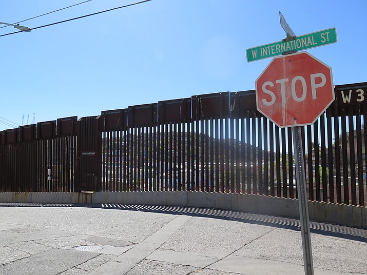 This Wednesday, March 9, photo shows a stop sign in front of the international border fence in Nogales, Ariz. Residents of this border neighborhood say presidential candidate Donald Trump’s idea to build a wall between Mexico and the United States is absurd.