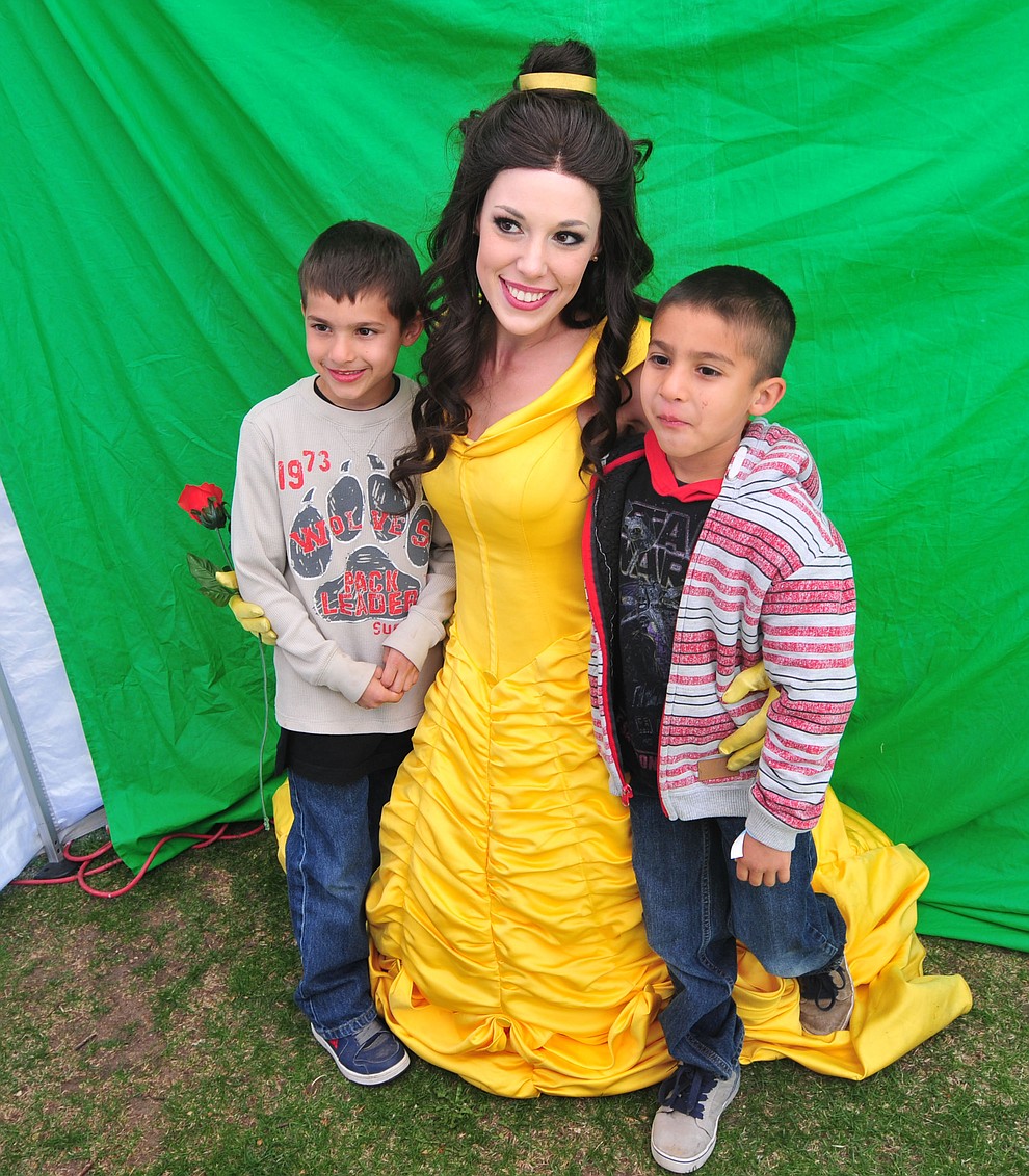 Felipe and Daniel Aguilar got their pictyure taken with Disney princess Belle during the Great Prescott Easter Egg Hunt Saturday morning on the Yavapai County Courthouse Plaza.(Les Stukenberg/The Daily Courier)