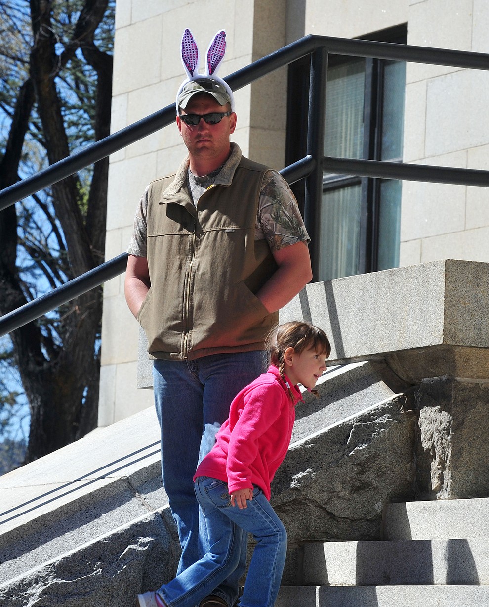 Jimmy Garrett got hs ears on for his daughter Sadie during the Great Prescott Easter Egg Hunt Saturday morning on the Yavapai County Courthouse Plaza.(Les Stukenberg/The Daily Courier)