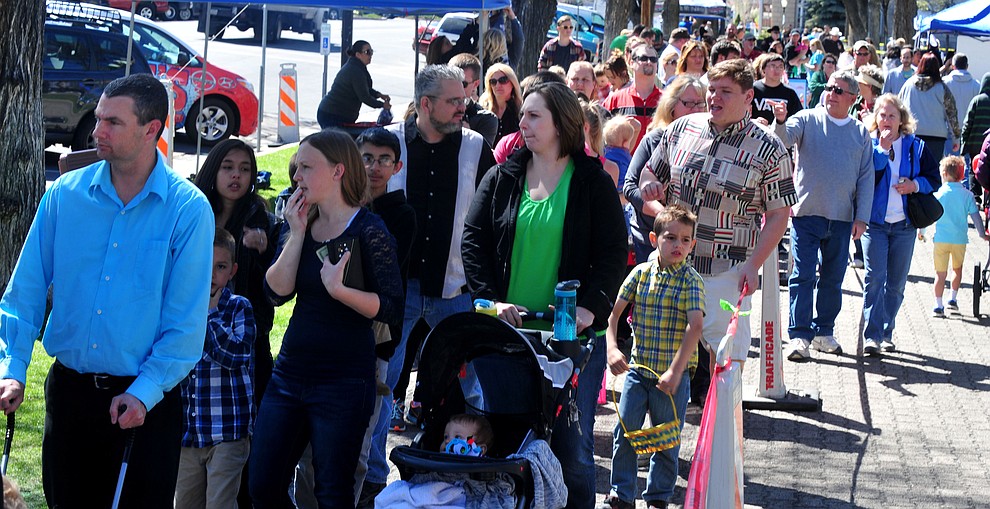 People wait in line to buy their wrist bands during the Great Prescott Easter Egg Hunt Saturday morning on the Yavapai County Courthouse Plaza.(Les Stukenberg/The Daily Courier)